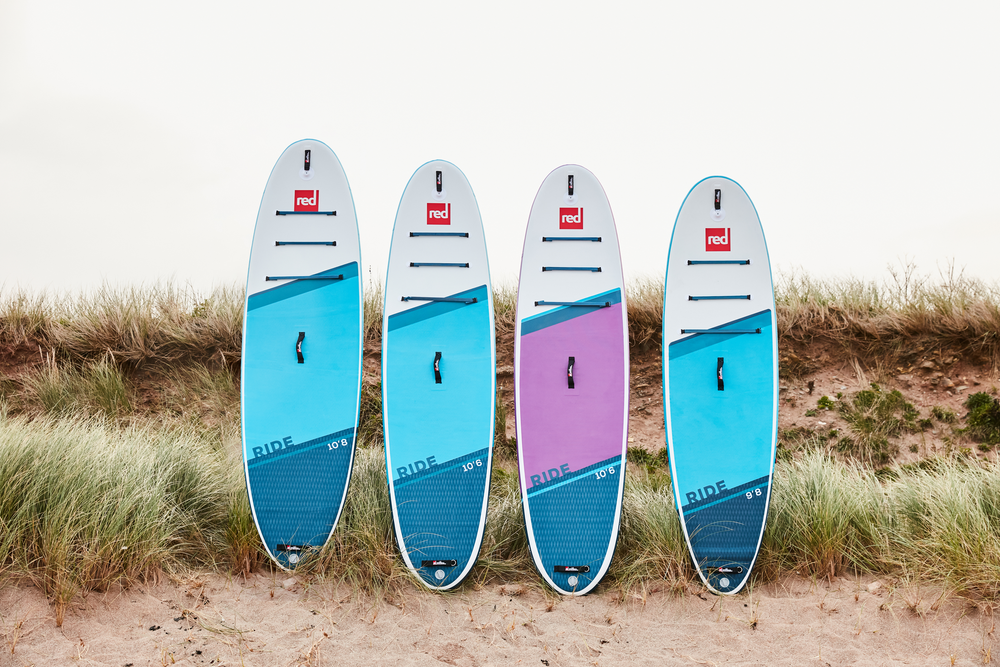 4 Red Paddle Co Ride MSL Paddle Boards Lined Up On A Beach