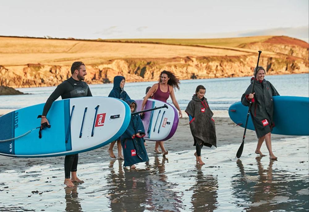 Family Walking with Paddle Boards