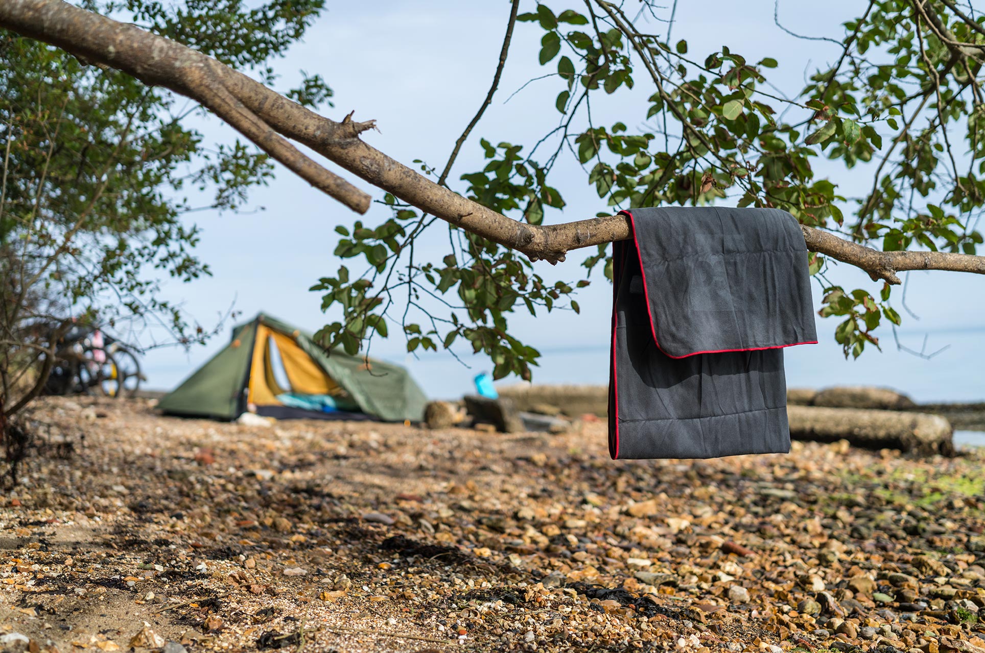 Towel hanging on a branch near a tent