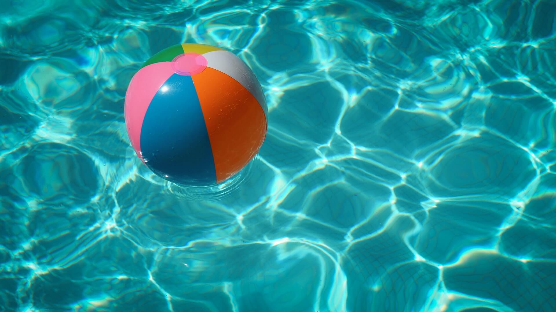 Inflatable ball floating in a pool