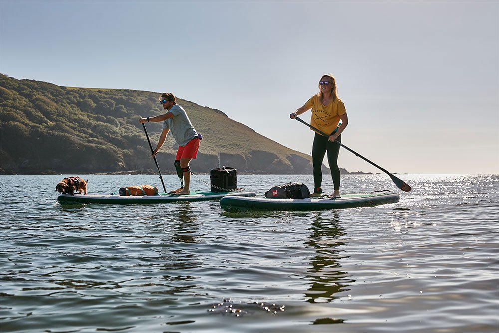 Man and woman paddle boarding on a lake