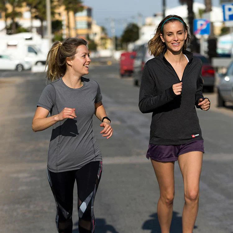 Two women running wearing Red original performance t-shirts